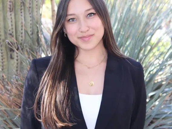 A headshot of Sara Draper with a bit of cactus showing in the background